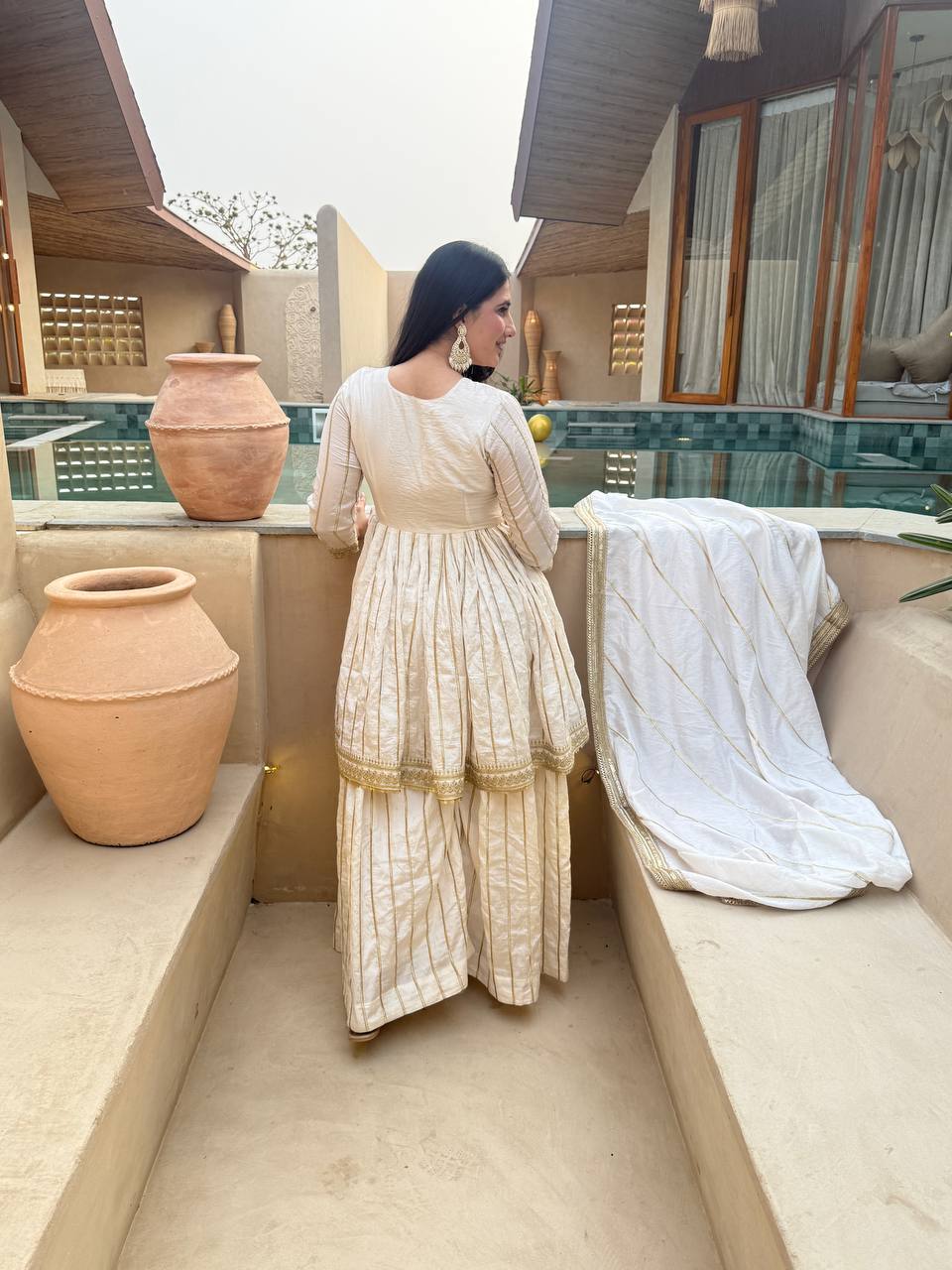 Radiant Rose Pink Flared Peplum Kurti and Sharara Set Embellished with Luminous Gold Zari Stripes and Sequined Borders